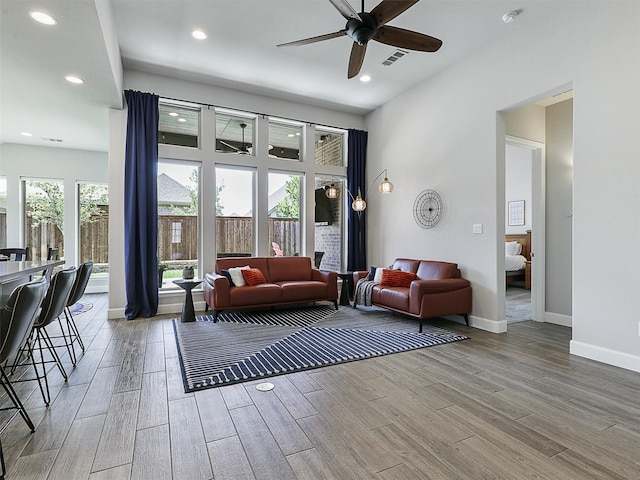 living area with ceiling fan, wood finished floors, visible vents, and recessed lighting