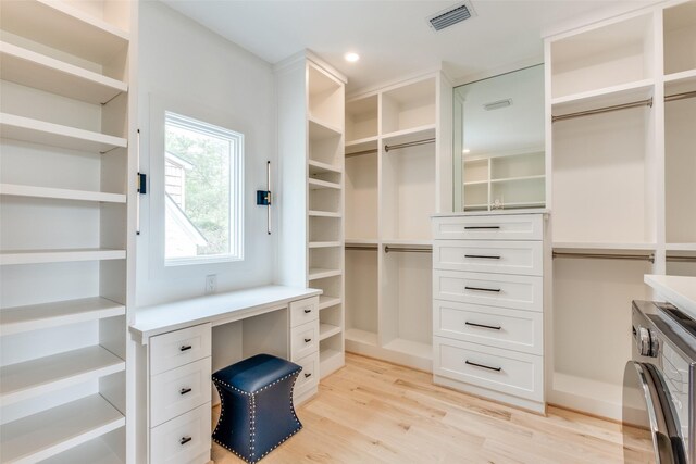 walk in closet featuring washer / dryer, visible vents, and light wood finished floors