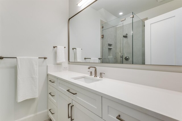 full bathroom with recessed lighting, vanity, and a stall shower