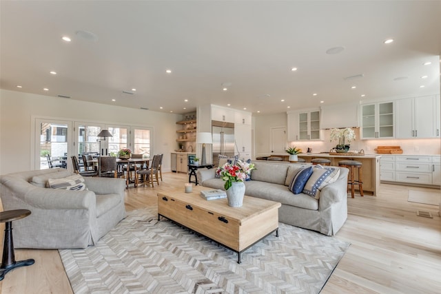 living room with recessed lighting and light wood-style floors