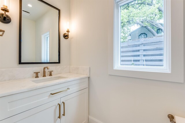 bathroom featuring baseboards and vanity