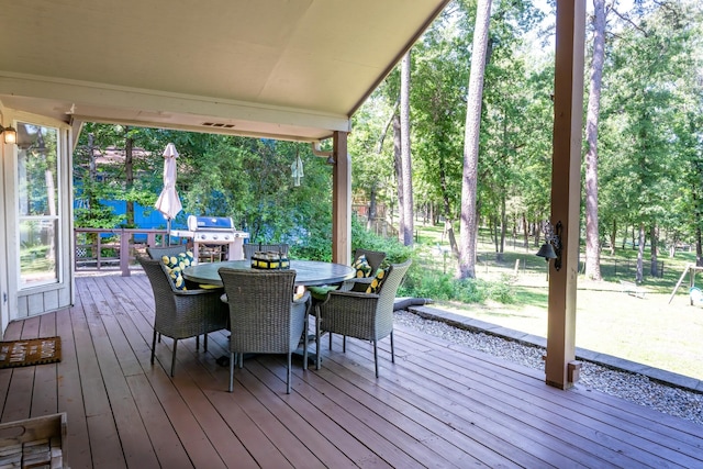 810 Clear Water Trl, Holly Lake Ranch, TX 75765 - deck featuring grilling area, view of wooded area, and outdoor dining area