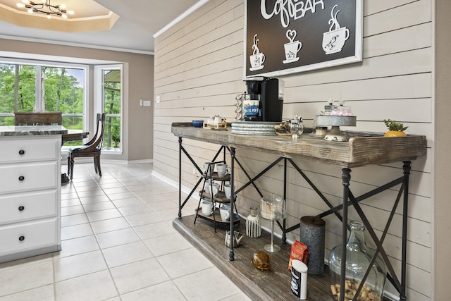 810 Clear Water Trl, Holly Lake Ranch, TX 75765 - dining space with wooden walls, light tile patterned flooring, baseboards, crown molding, and a chandelier