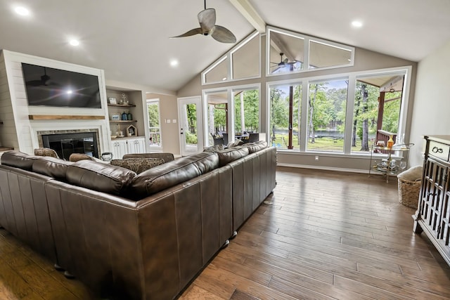810 Clear Water Trl, Holly Lake Ranch, TX 75765 - living room with a glass covered fireplace, a ceiling fan, healthy amount of natural light, dark wood finished floors, and recessed lighting