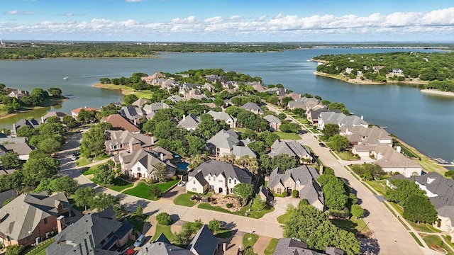 drone / aerial view with a residential view and a water view