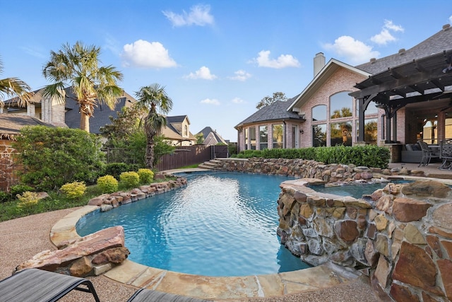view of swimming pool with a pergola, a patio area, a pool with connected hot tub, and a fenced backyard
