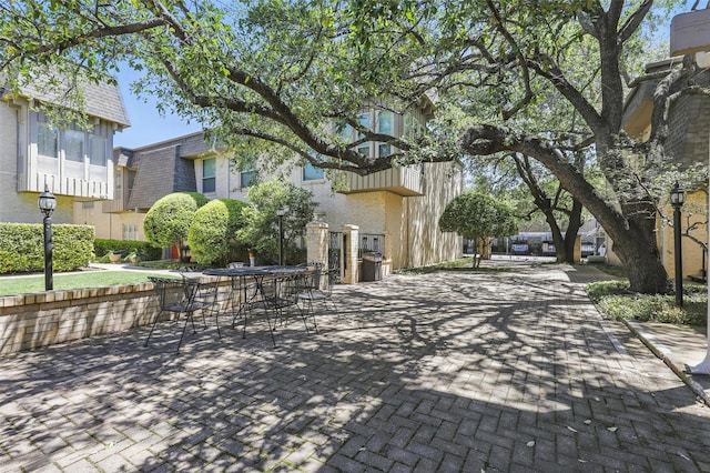 4320 Bellaire Dr S Unit 206W, Fort Worth, TX 76109 - surrounding community with a patio area and outdoor dining area