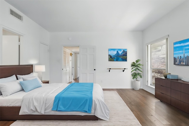 4320 Bellaire Dr S Unit 206W, Fort Worth, TX 76109 - bedroom with baseboards, wood finished floors, and visible vents