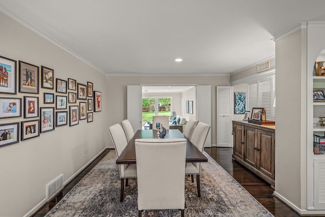 dining room featuring crown molding, dark wood-style flooring, and visible vents