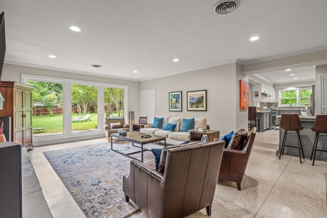 living room with recessed lighting, visible vents, ornamental molding, and light speckled floor