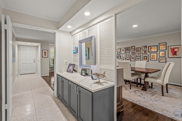 hall featuring baseboards, ornamental molding, speckled floor, and recessed lighting