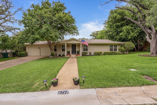 ranch-style house featuring an attached garage, driveway, and a front lawn