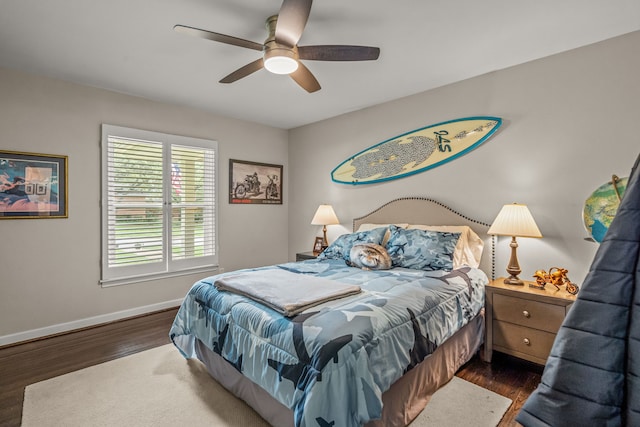 bedroom with baseboards, ceiling fan, and wood finished floors
