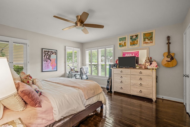 bedroom featuring baseboards, ceiling fan, and dark wood-style floors