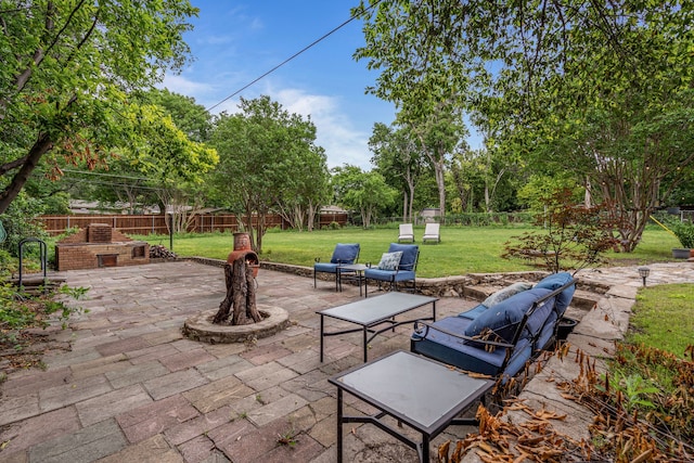 view of patio / terrace featuring an outdoor stone fireplace and a fenced backyard
