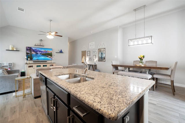 616 Chippewa Way, Aubrey, TX 76227 - kitchen featuring a sink, open floor plan, light wood-style floors, decorative light fixtures, and an island with sink