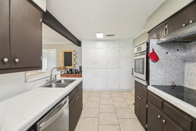 kitchen with tasteful backsplash, visible vents, appliances with stainless steel finishes, and a sink