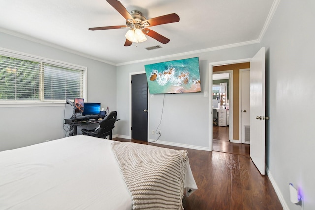 bedroom featuring baseboards, wood finished floors, visible vents, and crown molding