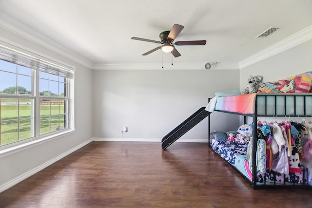 bedroom featuring wood finished floors, visible vents, and crown molding