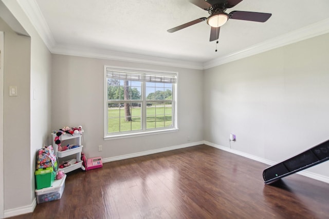 playroom featuring baseboards, crown molding, and wood finished floors