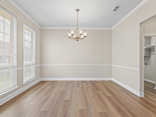 unfurnished room with baseboards, a notable chandelier, light wood-style floors, and visible vents
