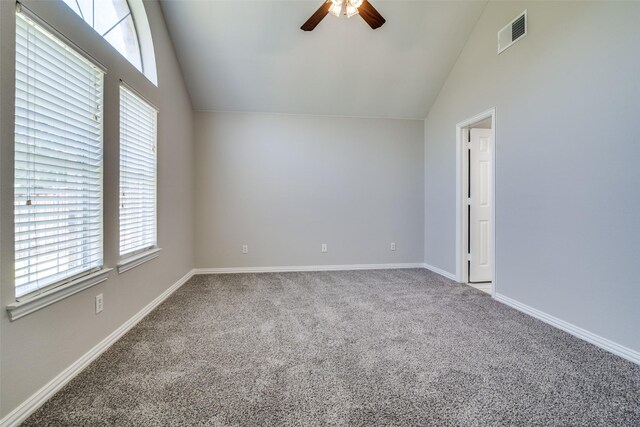 carpeted empty room featuring ceiling fan, lofted ceiling, visible vents, and baseboards