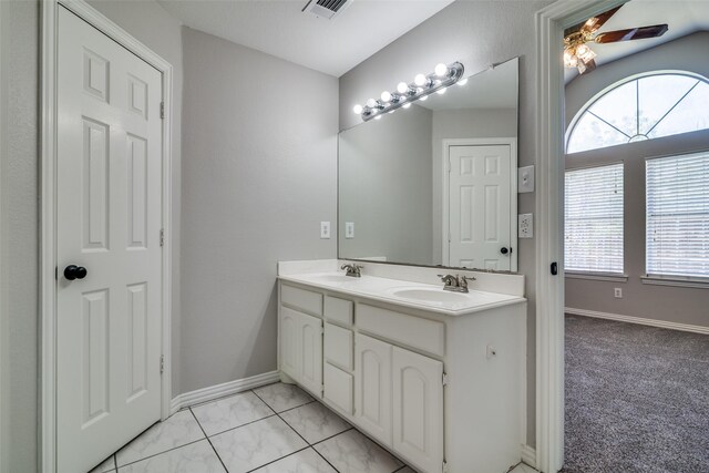 full bathroom with visible vents, a healthy amount of sunlight, ceiling fan, and a sink