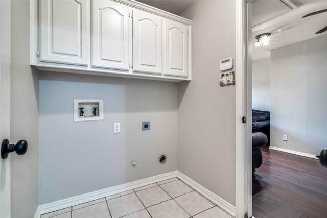 laundry area featuring hookup for an electric dryer, cabinet space, hookup for a washing machine, and baseboards
