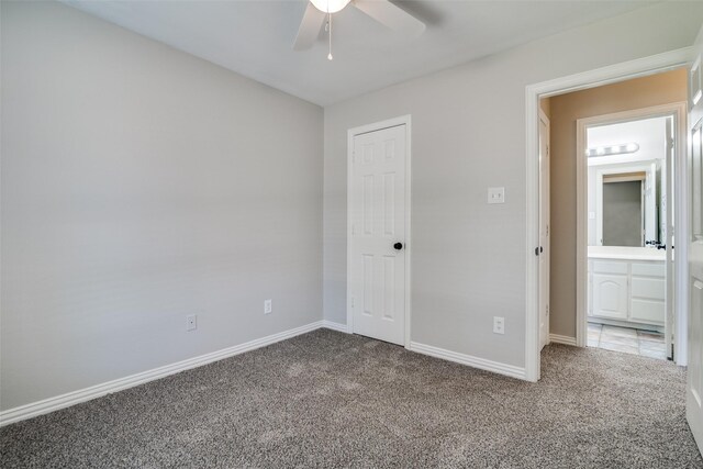 unfurnished bedroom with ceiling fan, baseboards, and carpet flooring