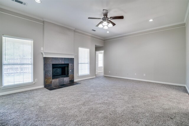 unfurnished living room featuring carpet floors, a healthy amount of sunlight, a ceiling fan, and visible vents