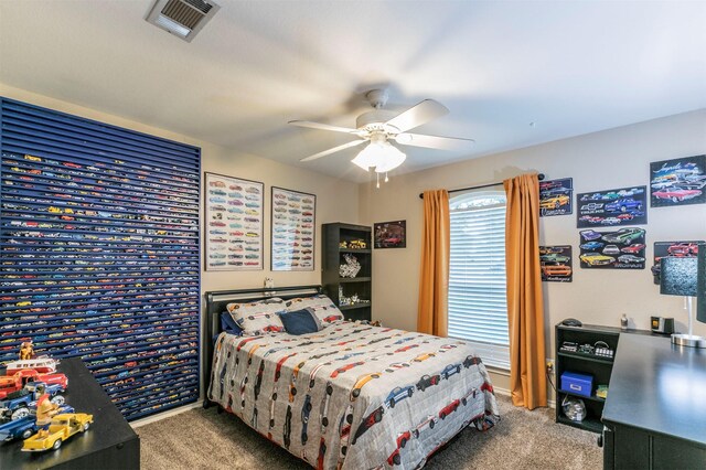 carpeted bedroom featuring visible vents and a ceiling fan