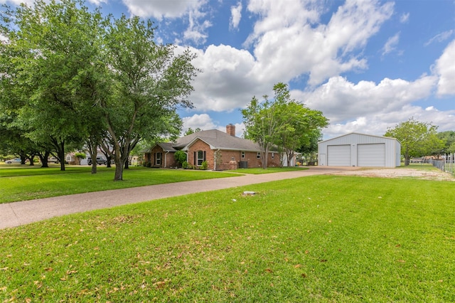 ranch-style house featuring a detached garage, a chimney, brick siding, an outdoor structure, and a front yard