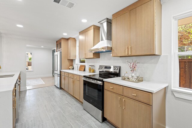 kitchen with wall chimney exhaust hood, light countertops, visible vents, and appliances with stainless steel finishes
