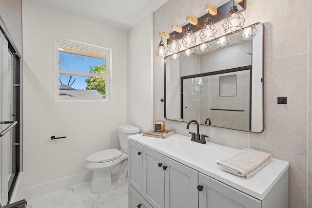 bathroom featuring a shower with shower door, toilet, baseboards, marble finish floor, and vanity