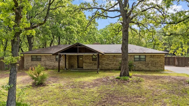 ranch-style house with brick siding and fence