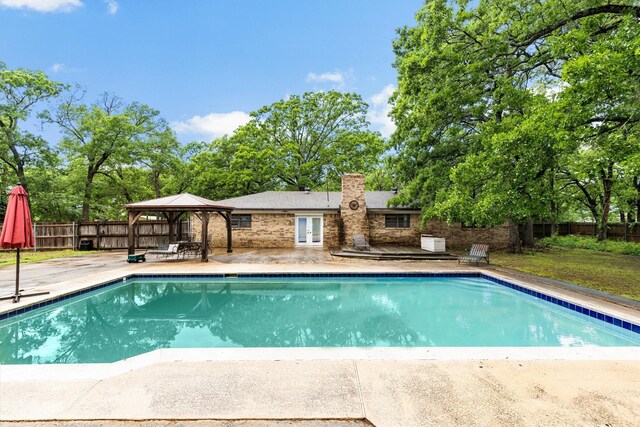 view of swimming pool with a fenced in pool, french doors, a fenced backyard, a gazebo, and a patio