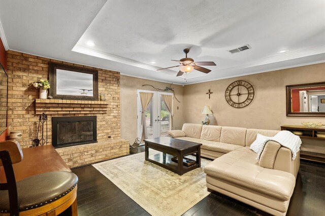 living room featuring ceiling fan, a fireplace, dark wood-type flooring, visible vents, and recessed lighting