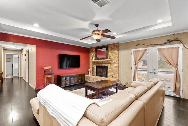 living area featuring a tray ceiling, dark wood finished floors, ceiling fan, and recessed lighting
