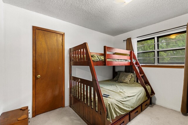 bedroom with carpet flooring and a textured ceiling