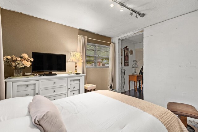 bedroom featuring track lighting