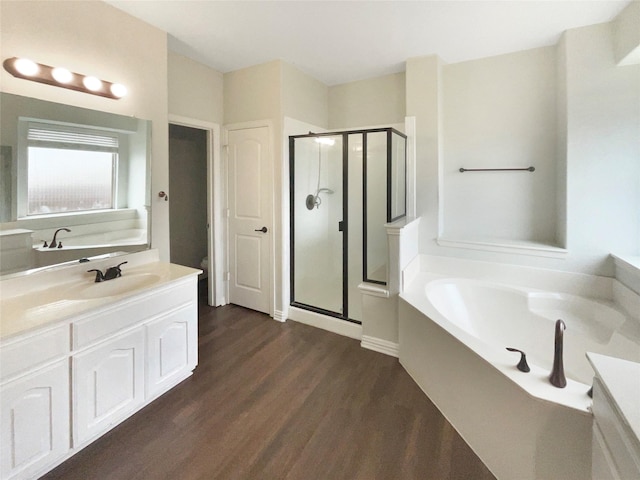 1005 Lake Hollow Dr, Little Elm, TX 75068 - full bathroom featuring wood finished floors, a stall shower, a bath, and vanity