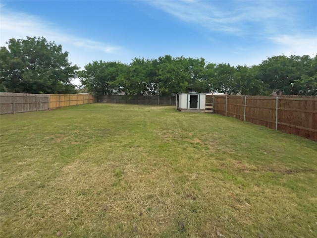 1005 Lake Hollow Dr, Little Elm, TX 75068 - view of yard with an outdoor structure, a storage unit, and a fenced backyard