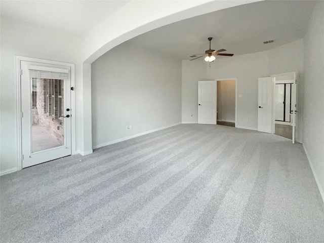 1005 Lake Hollow Dr, Little Elm, TX 75068 - unfurnished room featuring ceiling fan, arched walkways, light carpet, baseboards, and visible vents