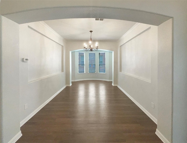 1005 Lake Hollow Dr, Little Elm, TX 75068 - unfurnished dining area featuring arched walkways, dark wood-style floors, visible vents, a notable chandelier, and crown molding
