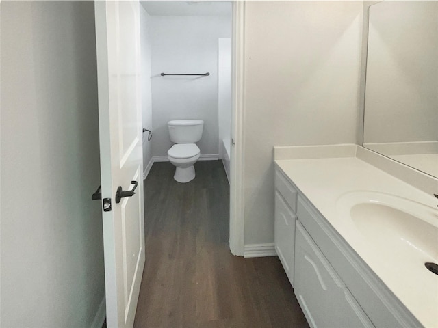 1005 Lake Hollow Dr, Little Elm, TX 75068 - bathroom featuring toilet, vanity, wood finished floors, and baseboards