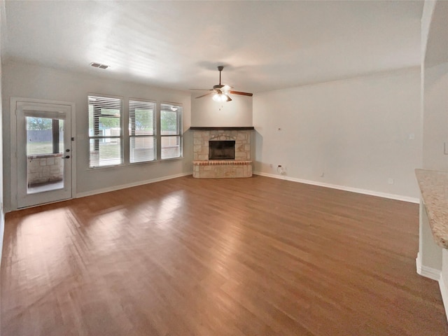 1005 Lake Hollow Dr, Little Elm, TX 75068 - unfurnished living room featuring visible vents, ceiling fan, plenty of natural light, and a stone fireplace