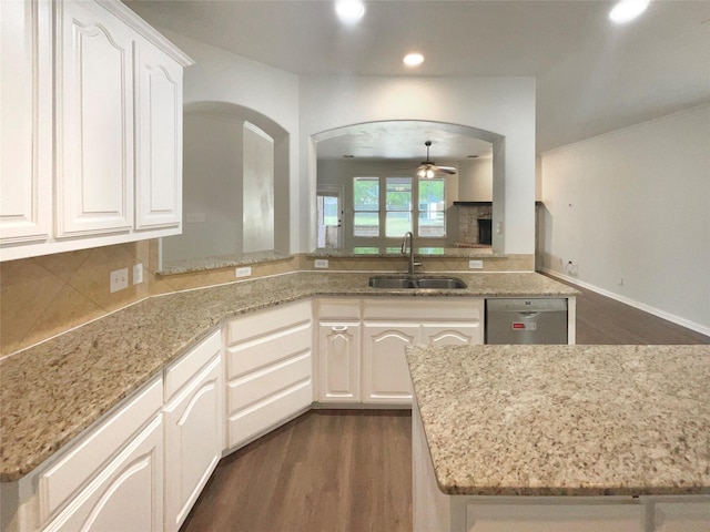 1005 Lake Hollow Dr, Little Elm, TX 75068 - kitchen featuring a ceiling fan, stainless steel dishwasher, a sink, arched walkways, and dark wood-style flooring