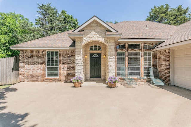 1944 Nottingham Dr, Kaufman, TX 75142 - entrance to property with brick siding, roof with shingles, stone siding, and a patio