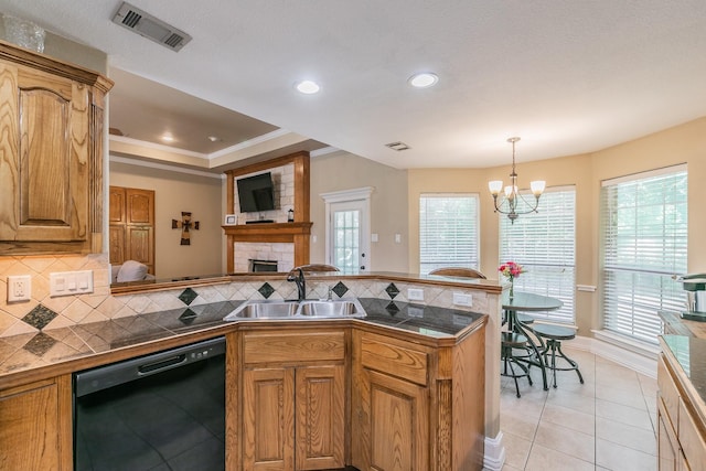 1944 Nottingham Dr, Kaufman, TX 75142 - kitchen featuring a stone fireplace, a sink, dishwasher, a peninsula, and visible vents