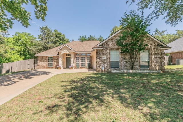 1944 Nottingham Dr, Kaufman, TX 75142 - doorway to property featuring brick siding, roof with shingles, stone siding, and a patio